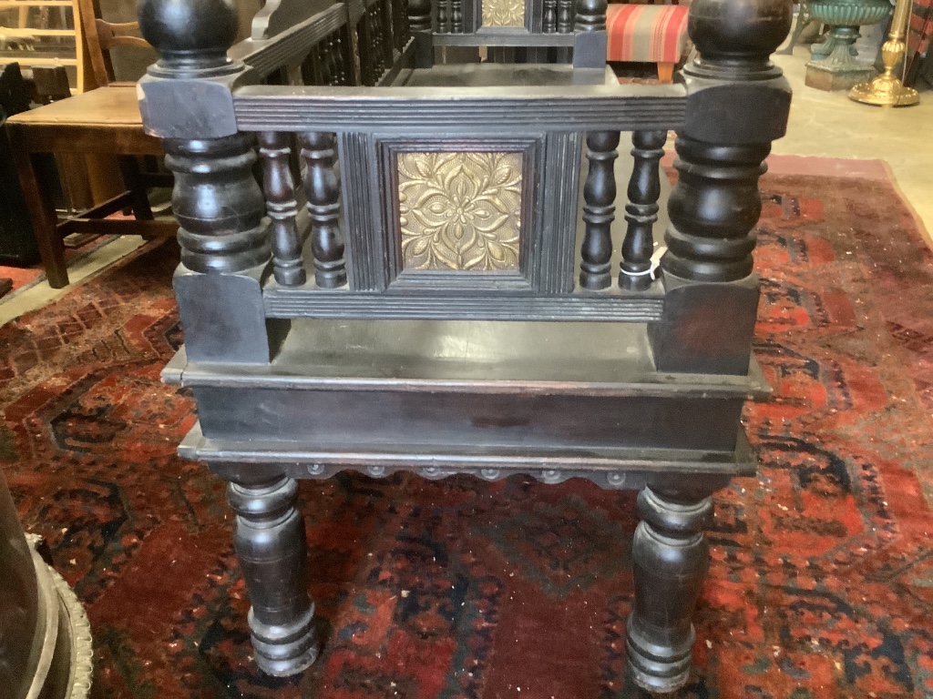 A Victorian Aesthetic period ebonised hall seat, the raised back with embossed glass inset panels, width 182cm depth 61cm height 96cm